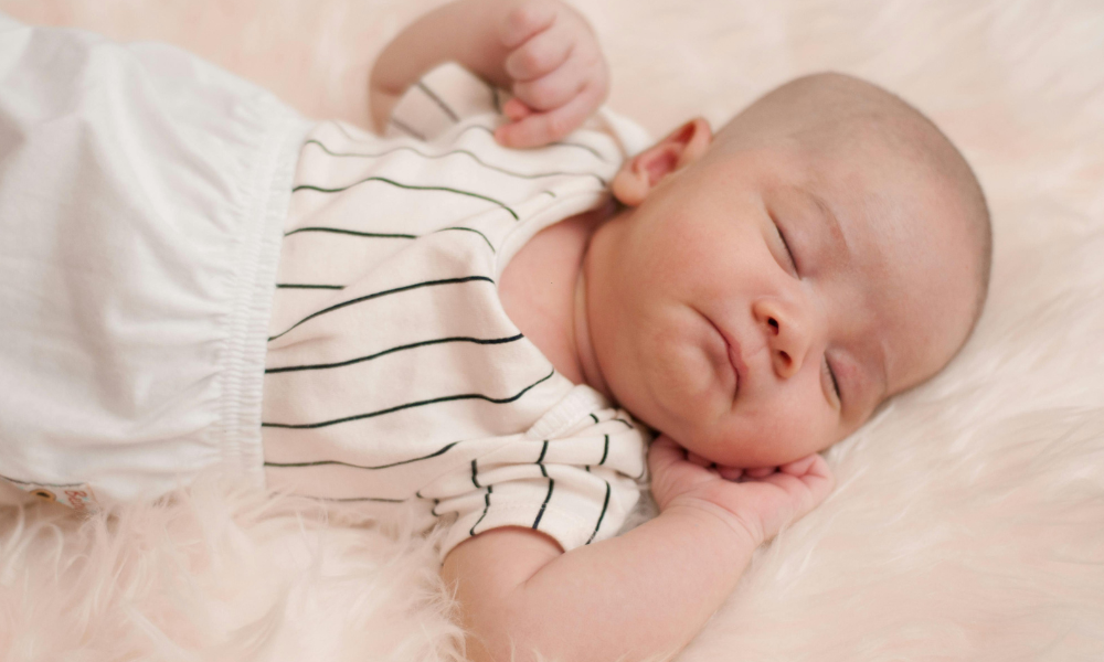 Why do Babies Sleep With Their Arms photo