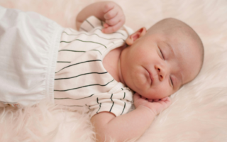 Why do Babies Sleep With Their Arms photo