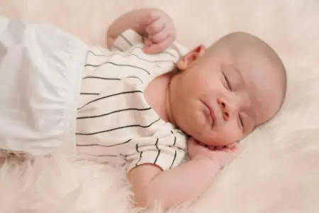 Why do Babies Sleep With Their Arms photo